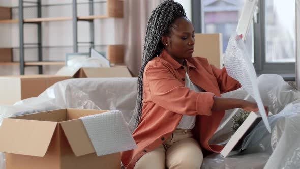 Happy Woman Packing Box and Moving to New Home