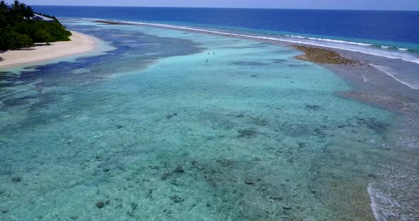 Wide angle flying island view of a sunshine white sandy paradise beach and aqua blue ocean background