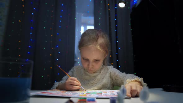 Caucasian girl painting at home