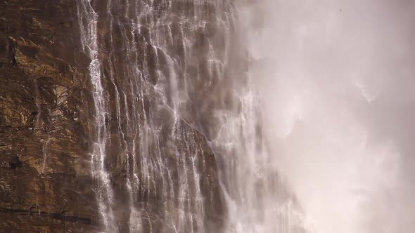 Water dripping of the soaked rock at the base of a waterfall.