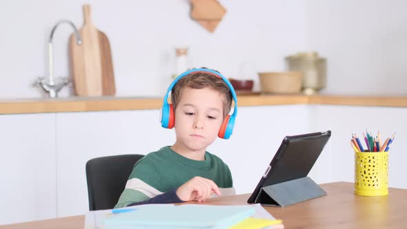 Cute Little Boy Watching Cartoons on a Tablet