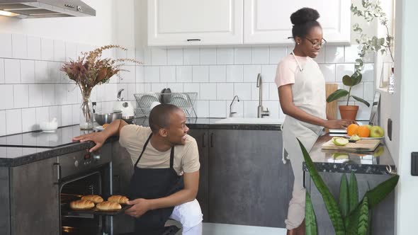 Happy Man Takes Out Baked Goods From Oven, Looks Whether It Is Ready or Not.