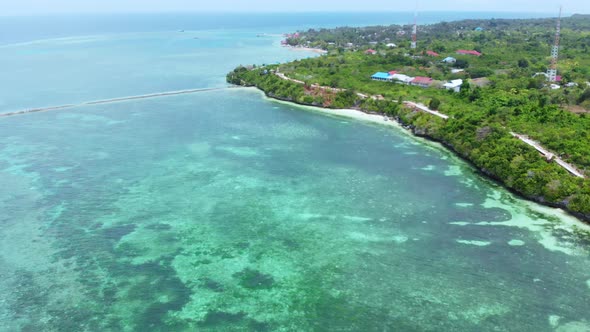 Aerial: Flying over tropical beach turquoise water coral reef, Indonesia 