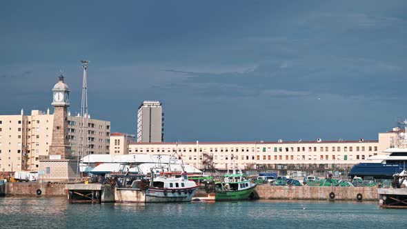 Sea port in Barcelona, Spain. Moored yachts, buildings on the background, lighthouse