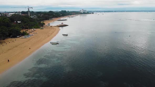 Beautiful cinematic Sanur beach, Bali drone footage with interesting landscape, fishing boats and ca