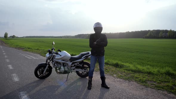 Biker Standing Next To Motorcycle