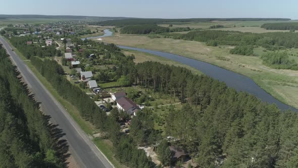 Aerial view of private houses in the forest next to the river 15