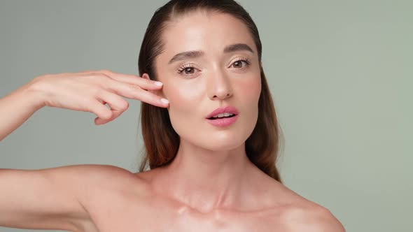 Beautiful Young Woman with Clean Fresh Skin Standing Over Light Grey Background / Videohive, Stock footage, People