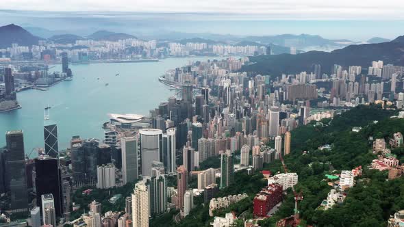 4k aerial video of Victoria Harbour in Hong Kong. Hong Kong Aerial View Day to Night Cityscape (pan