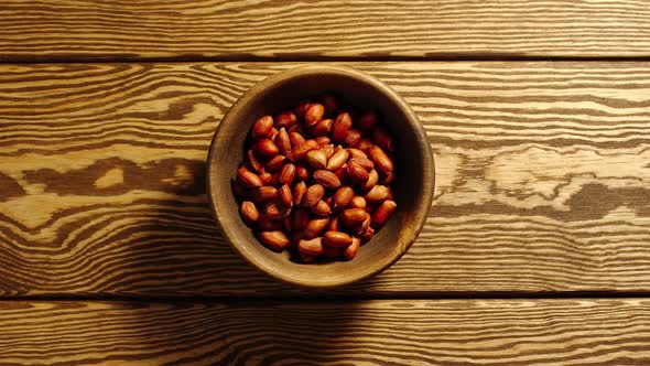 Peeled peanuts appear in wooden cup and full this cup