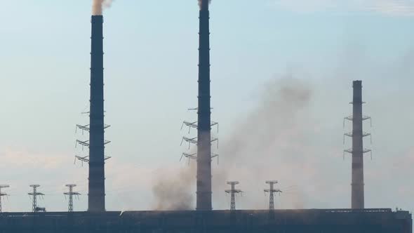 Coal Power Plant High Pipes with Black Smoke Moving Upwards Polluting Atmosphere