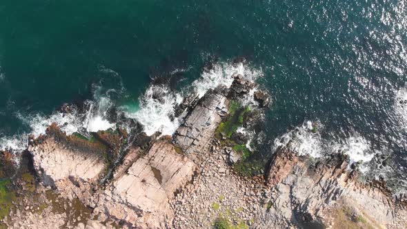 Sea waves crashing into rocky shore