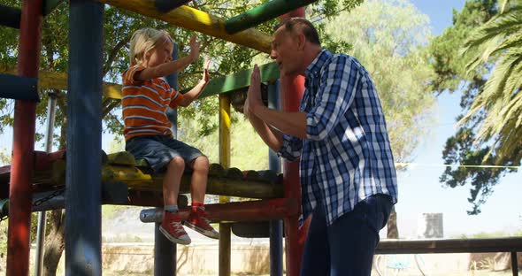 Father and son having fun at playground 4k
