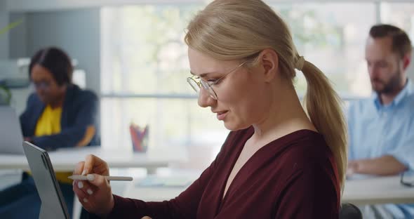 Closeup Woman Designer Using Graphics Tablet at Office Workplace