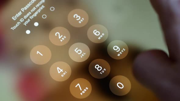 Close-up of a finger typing a password on a gadget trying to pass the verification.