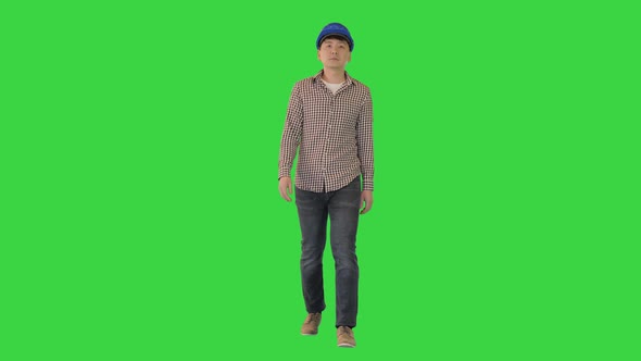 Construction Man in a Hardhat Walking on a Green Screen Chroma Key