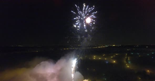 An aerial view of a huge beautiful firework in a pitch black sky