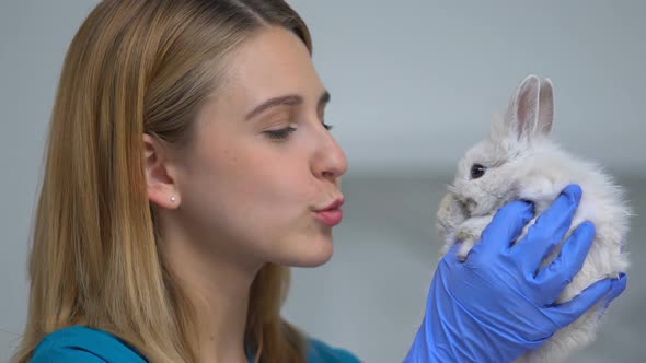 Female Vet Playing With Cute Rabbit, Reducing Stress Before Health Care Exam