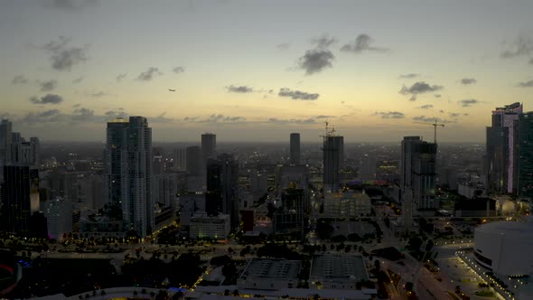 Airplane Flying Over Downtown Miami City Landscape Twilight