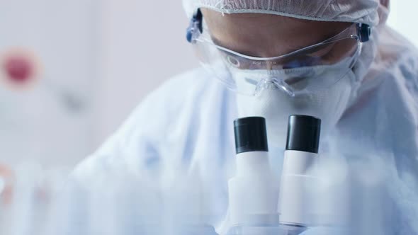 Close Up Shot of Chemist Scientist Looking at Microscope alt