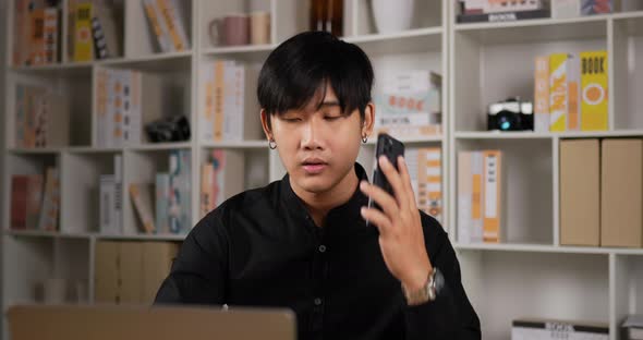 Businessman working on laptop and talking on phone