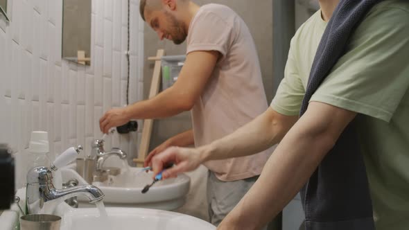 Male Couple Brushing Teeth before Bed