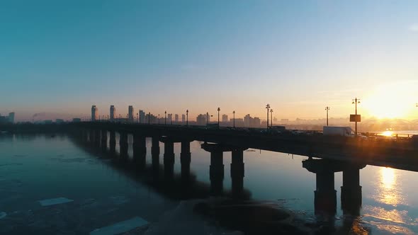 Sunset Over the Bridge with Traffic in the City