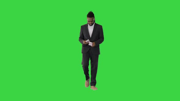 Black Man in Office Suit Walk Counting Money on a Green Screen Chroma Key