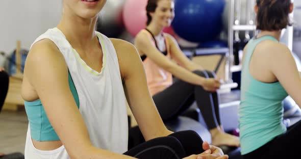 Beautiful woman sitting in fitness studio