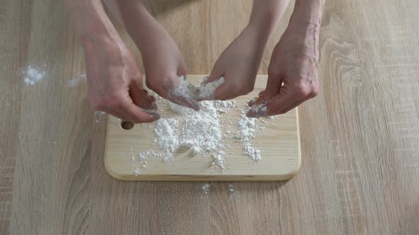 Hands of Grandmother and Granddaughter Pouring Flour on Plank, Cooking Time