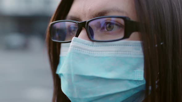 Closeup Eyes of a Girl in Glasses and a Medical Mask