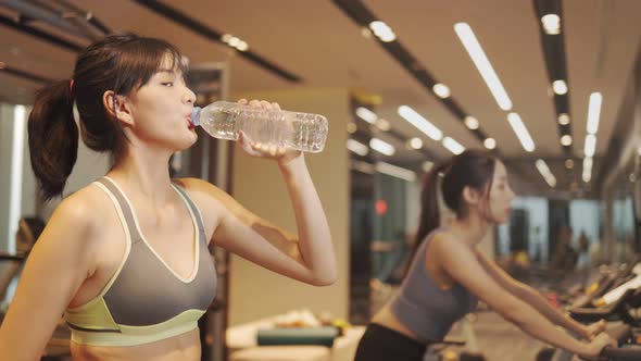 Young beautiful asian woman running on a treadmill at gym. Fitness and healthy