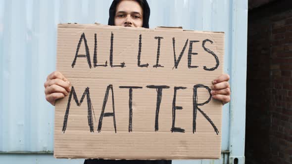 Caucasian Man are Protesting in the Street with Megaphones and Signs