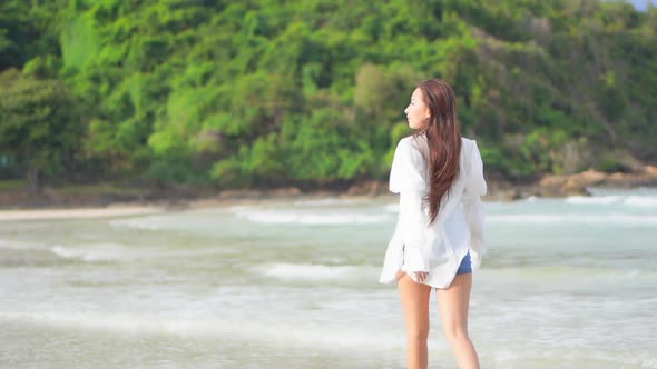 Asian woman enjoy around beautiful beach sea ocean