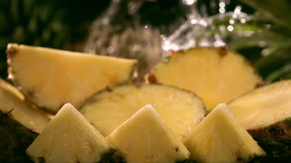 Slow Motion Shot of Pineapple and Water Splashing Through Pineapple Slices