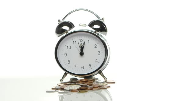 Alarm Clock and Coins. Close Up