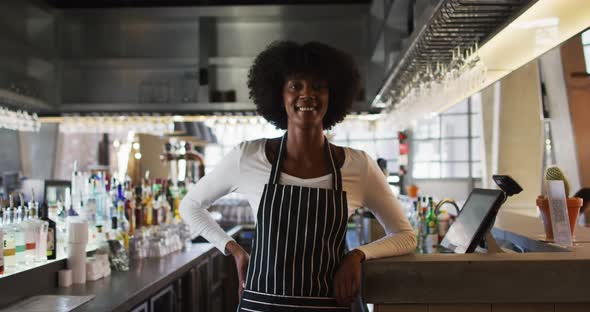 Portrait of happy african american female cafe worker looking at the camera and smiling