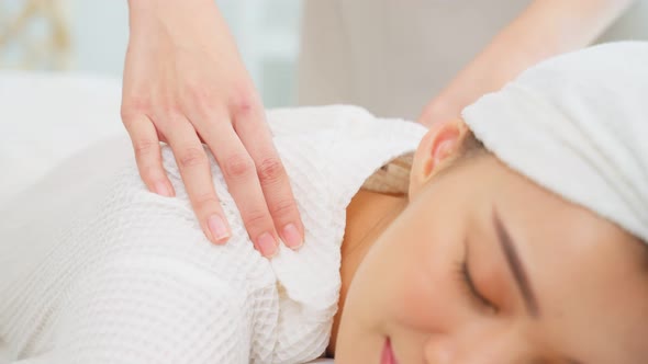 Asian young happy woman feeling relax during shoulder and back massage.