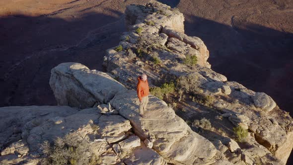 Aerial shot of a hiker at the the edge of Cedar Mesa in Utah