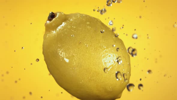 Flying of Lemon in Yellow Background in Slow Motion