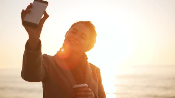 Attractive Young Lady Making Selfie Agains Sea During Sunrise in Slowmotion