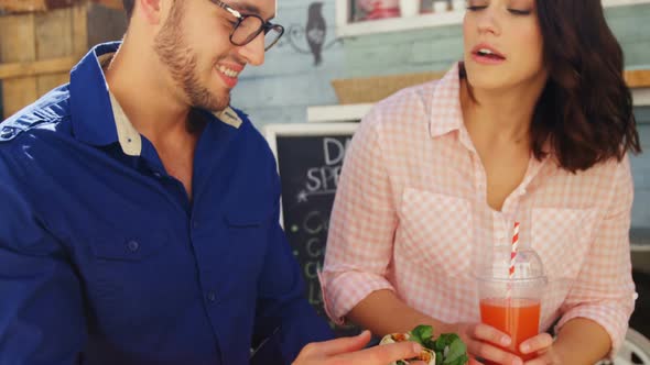 Couple interacting while having snacks and juice