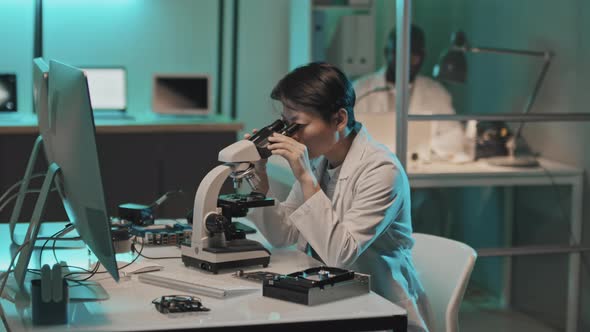 Portrait of Asian Female Engineer with Microscope in Lab