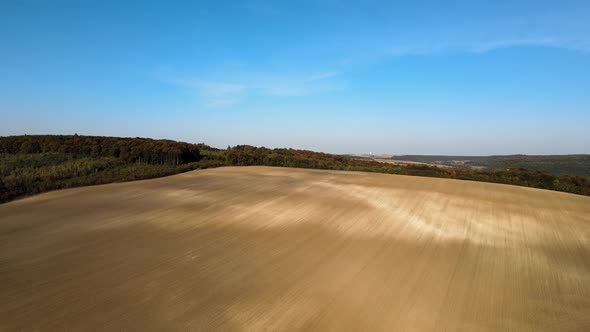 Plowed Agricultural Field with Cultivated Fertile Soil Prepared for Planting Crops in Spring