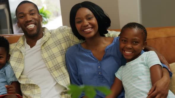 Family sitting together in living room 4k