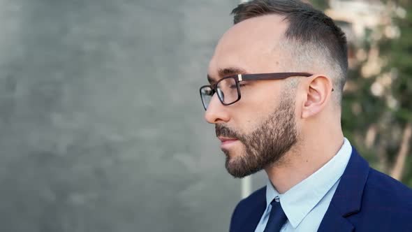 Closeup Face of Bearded Man in Glasses and Tie Going at Office Building
