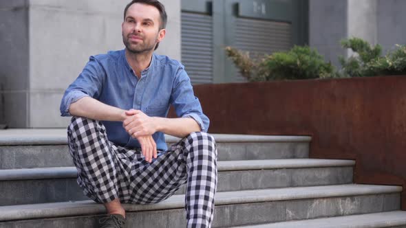 Pensive Casual Man Thinking and Sitting Relax on Stairs