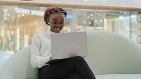 Happy Smiling Girl African American Student Business Woman Freelancer Sitting on Sofa in Office