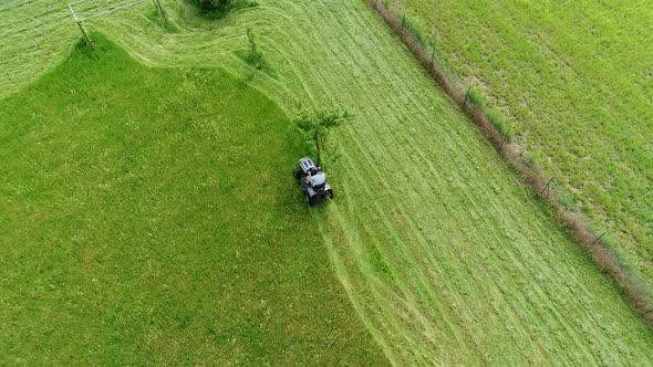 Riding lawn mower in action seen from the sky