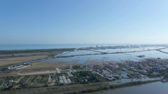 Aerial Drone Footage of the Agricultural Fields Village Submerged in Water with Blue Sky White